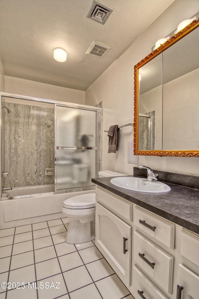 7146 E Sabino Vista Cir, Tucson, AZ 85750 - full bathroom with tile patterned floors, combined bath / shower with glass door, toilet, and vanity