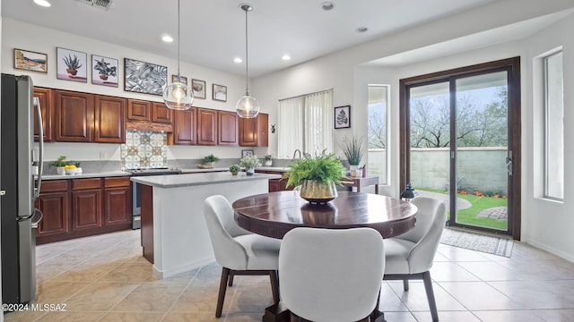 15083 S Placita Rancho Verano, Sahuarita, AZ 85629 - kitchen featuring appliances with stainless steel finishes, light countertops, recessed lighting, light tile patterned flooring, and a center island