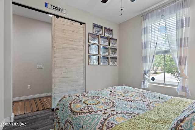 14233 E Hub Dr, Vail, AZ 85641 - bedroom with wood finished floors, a barn door, baseboards, and ceiling fan