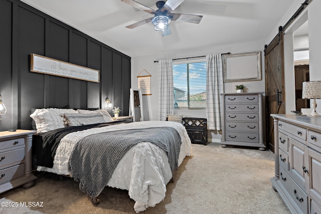 14233 E Hub Dr, Vail, AZ 85641 - bedroom featuring light carpet, a barn door, and a ceiling fan