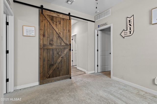 14233 E Hub Dr, Vail, AZ 85641 - hall with carpet, a barn door, and baseboards