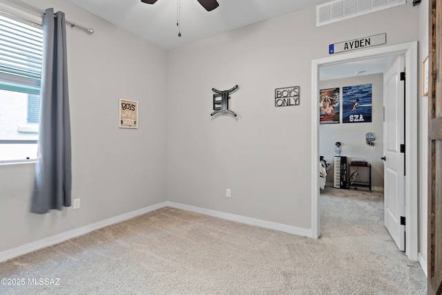14233 E Hub Dr, Vail, AZ 85641 - spare room with light carpet, a ceiling fan, and baseboards