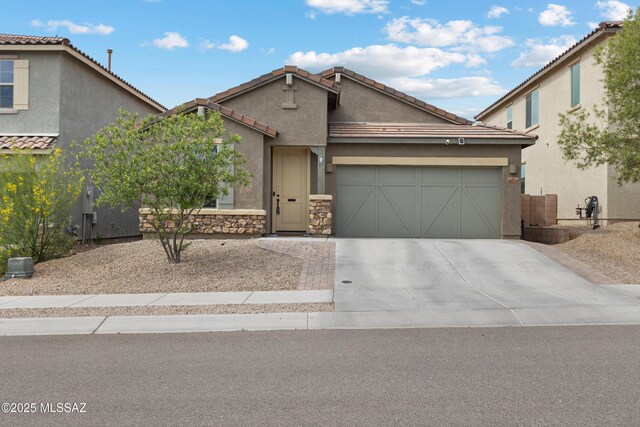 14233 E Hub Dr, Vail, AZ 85641 - view of front of house with an attached garage, driveway, stucco siding, and a tile roof