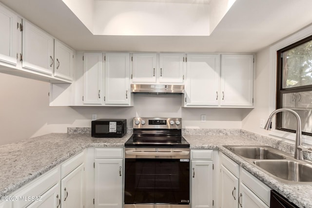 kitchen with black appliances, a sink, under cabinet range hood, and white cabinetry
