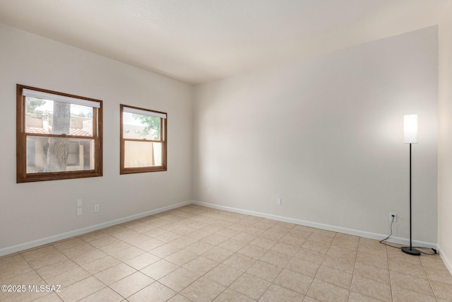 spare room with baseboards