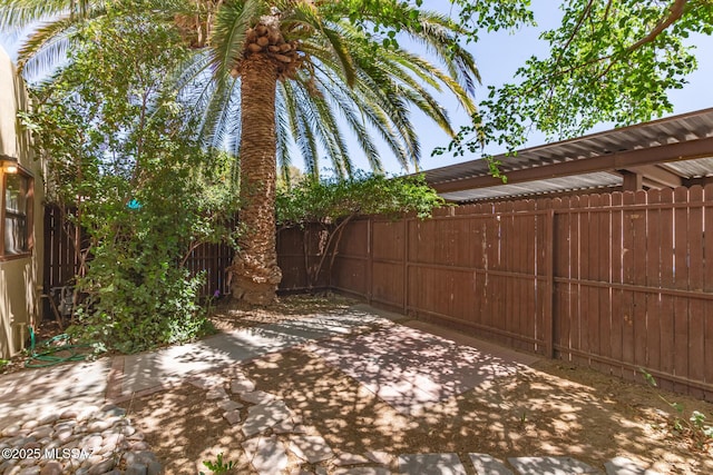 fenced backyard with a patio area