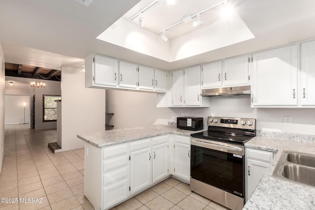 kitchen with stainless steel electric range, under cabinet range hood, light tile patterned floors, rail lighting, and black microwave