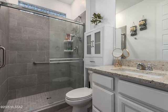 7988 S Bonanza Park Dr, Tucson, AZ 85747 - bathroom featuring a stall shower, toilet, and vanity