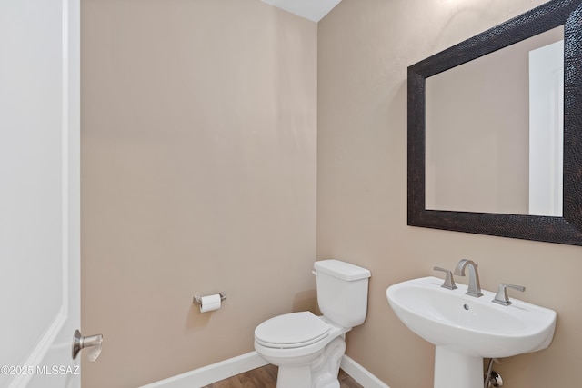 60922 E Arbor Basin Rd, Oracle, AZ 85623 - half bathroom with toilet, a sink, baseboards, and wood finished floors