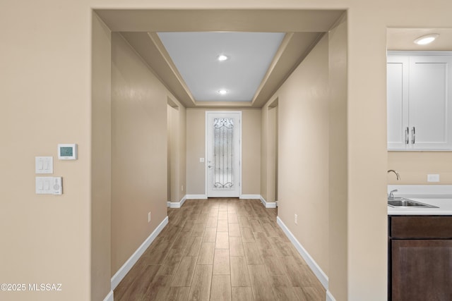 60922 E Arbor Basin Rd, Oracle, AZ 85623 - hall featuring a sink, light wood-style floors, baseboards, a tray ceiling, and recessed lighting