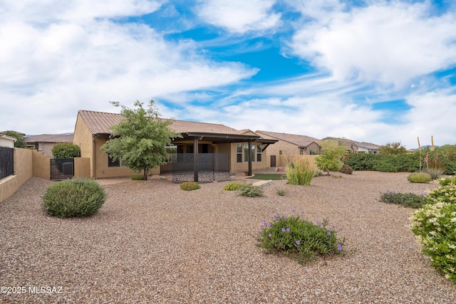 60922 E Arbor Basin Rd, Oracle, AZ 85623 - back of property featuring stucco siding, a tiled roof, and a gate