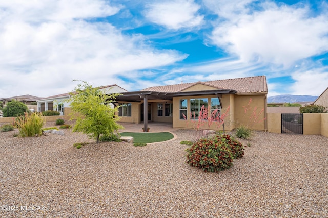 60922 E Arbor Basin Rd, Oracle, AZ 85623 - rear view of house featuring a gate, a tiled roof, stucco siding, and a patio