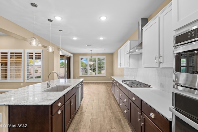 60922 E Arbor Basin Rd, Oracle, AZ 85623 - kitchen featuring a sink, stainless steel appliances, white cabinetry, light wood-style flooring, and dark brown cabinetry