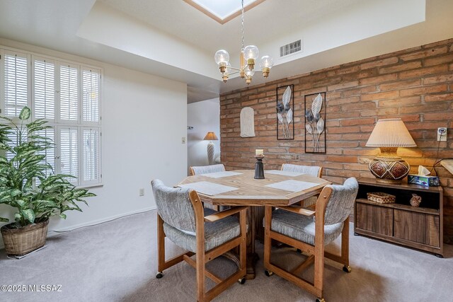 723 S Los Zafiros, Green Valley, AZ 85614 - dining room with light carpet, a chandelier, brick wall, and baseboards