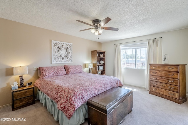 723 S Los Zafiros, Green Valley, AZ 85614 - bedroom with light colored carpet, baseboards, ceiling fan, and a textured ceiling