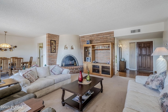 723 S Los Zafiros, Green Valley, AZ 85614 - carpeted living room featuring a textured ceiling and a brick fireplace