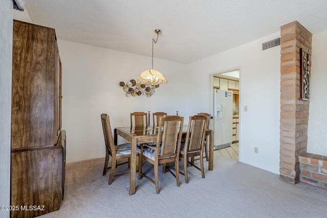 723 S Los Zafiros, Green Valley, AZ 85614 - dining area featuring light colored carpet, a chandelier, and a textured ceiling