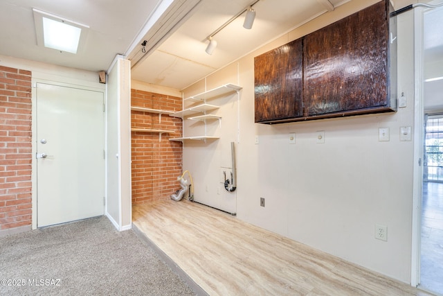 2 S Antietam Pl, Tucson, AZ 85710 - laundry area featuring brick wall, track lighting, and carpet