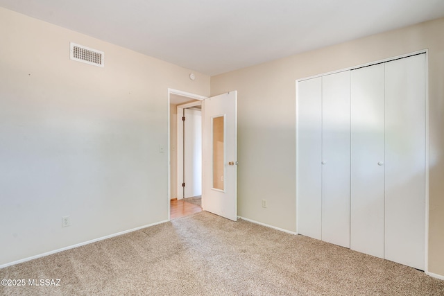 2 S Antietam Pl, Tucson, AZ 85710 - unfurnished bedroom featuring light colored carpet, a closet, and baseboards