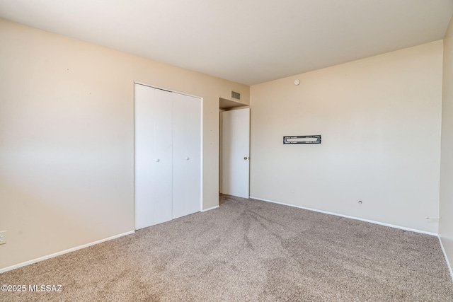 2 S Antietam Pl, Tucson, AZ 85710 - unfurnished bedroom featuring carpet floors, a closet, and baseboards