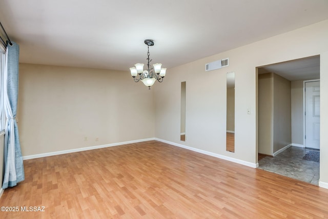 2 S Antietam Pl, Tucson, AZ 85710 - unfurnished room featuring light wood-type flooring, a chandelier, and baseboards
