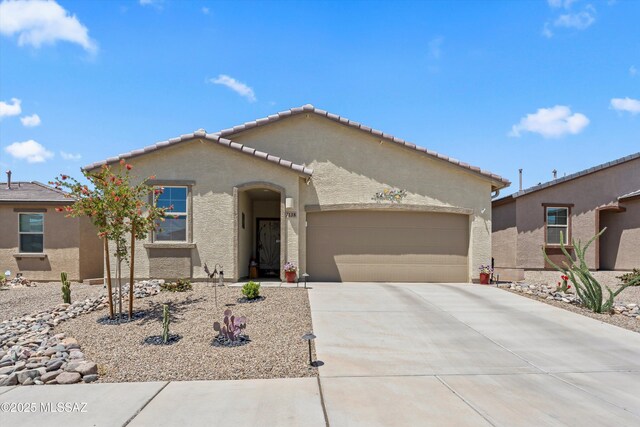 7138 W Ferntree Ln, Tucson, AZ 85757 - mediterranean / spanish home featuring stucco siding, a garage, concrete driveway, and a tile roof