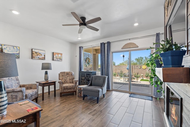 7138 W Ferntree Ln, Tucson, AZ 85757 - sitting room featuring ceiling fan, recessed lighting, wood finished floors, wine cooler, and a glass covered fireplace