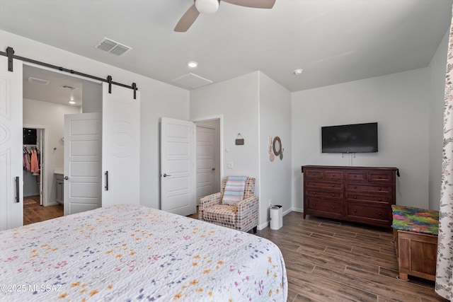 7138 W Ferntree Ln, Tucson, AZ 85757 - bedroom with a barn door, dark wood-type flooring, ceiling fan, and a spacious closet