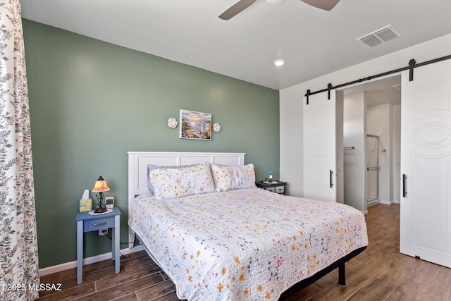 7138 W Ferntree Ln, Tucson, AZ 85757 - bedroom with a barn door, wood finished floors, baseboards, a ceiling fan, and recessed lighting