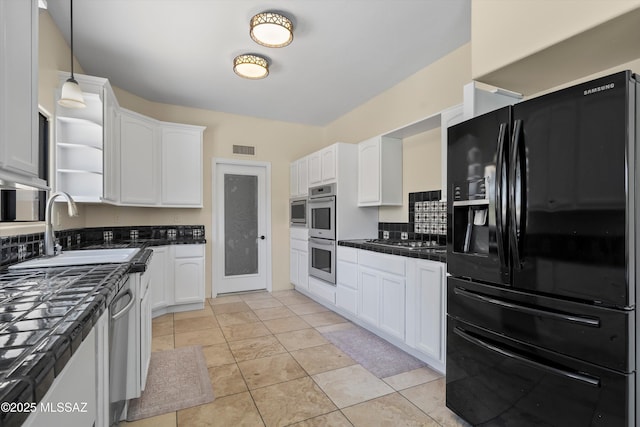 11300 N Scioto Ave, Oro Valley, AZ 85737 - kitchen featuring appliances with stainless steel finishes, a sink, dark countertops, and white cabinets
