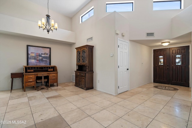 11300 N Scioto Ave, Oro Valley, AZ 85737 - foyer entrance featuring a chandelier, a high ceiling, and light tile patterned floors