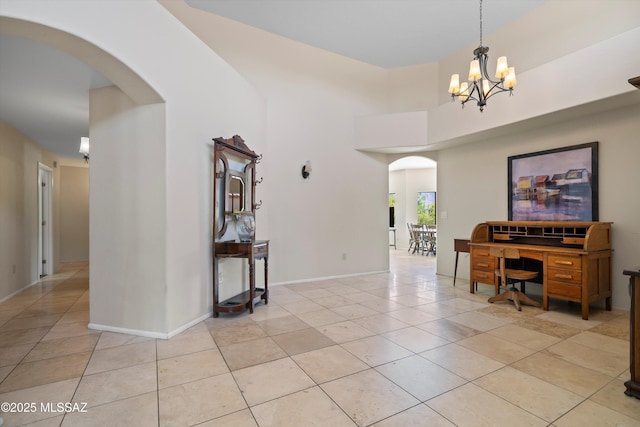11300 N Scioto Ave, Oro Valley, AZ 85737 - interior space featuring arched walkways, light tile patterned floors, a chandelier, baseboards, and a towering ceiling