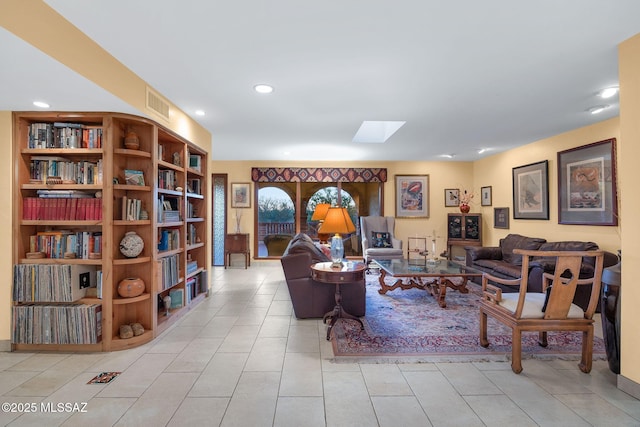 living area featuring recessed lighting, a skylight, and tile patterned flooring