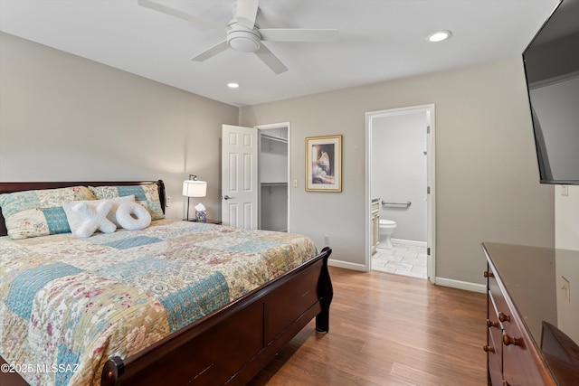 7624 E Helen St, Tucson, AZ 85715 - bedroom with wood finished floors, recessed lighting, baseboards, a walk in closet, and ensuite bath