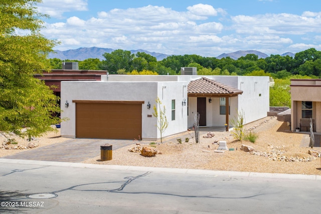 2125 Embarcadero Way, Tubac, AZ 85646 - view of front facade featuring a mountain view, an attached garage, cooling unit, and driveway