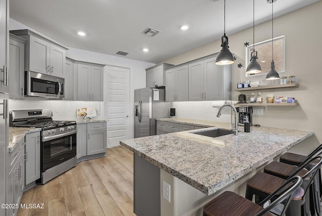 2125 Embarcadero Way, Tubac, AZ 85646 - kitchen with stainless steel appliances, gray cabinetry, a sink, a peninsula, and recessed lighting