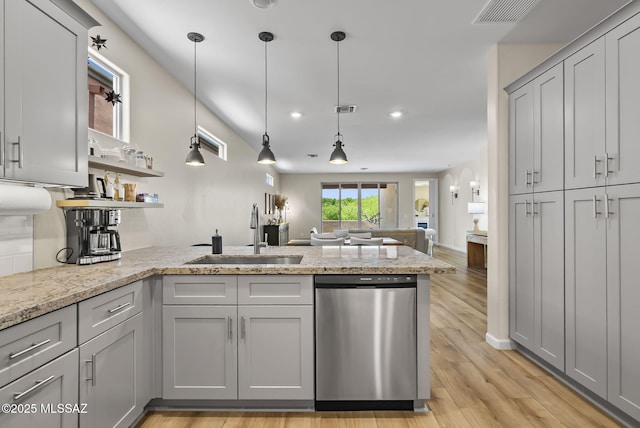 2125 Embarcadero Way, Tubac, AZ 85646 - kitchen featuring a sink, a peninsula, stainless steel dishwasher, open floor plan, and light wood-type flooring