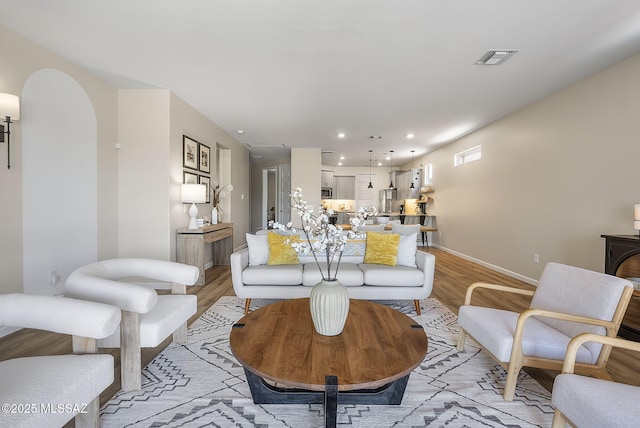 2125 Embarcadero Way, Tubac, AZ 85646 - living area featuring light wood-style flooring, arched walkways, baseboards, and recessed lighting