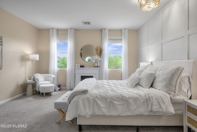 2125 Embarcadero Way, Tubac, AZ 85646 - bedroom with multiple windows, carpet flooring, baseboards, and a fireplace