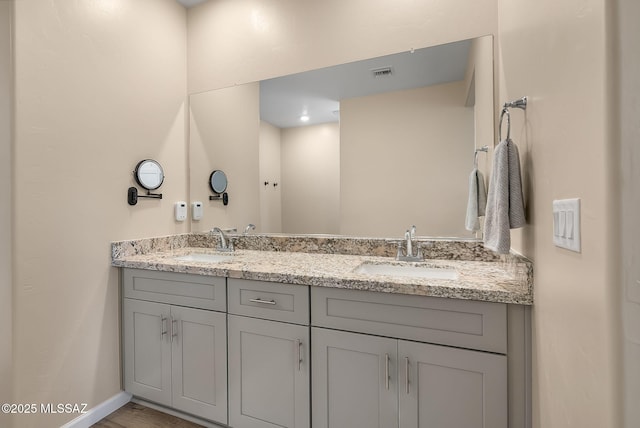 2125 Embarcadero Way, Tubac, AZ 85646 - bathroom with double vanity, baseboards, and wood finished floors