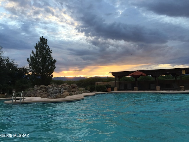 2125 Embarcadero Way, Tubac, AZ 85646 - pool at dusk with a community pool