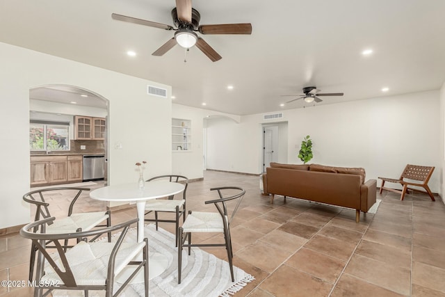5050 N Crestridge Dr, Tucson, AZ 85718 - dining space featuring arched walkways, a ceiling fan, recessed lighting, and baseboards