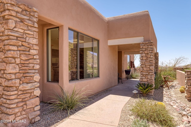 14198 N Gallery Pl, Marana, AZ 85658 - doorway to property with stone siding, stucco siding, and a patio area