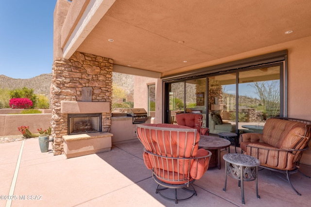 14198 N Gallery Pl, Marana, AZ 85658 - view of patio featuring an outdoor stone fireplace, a mountain view, and grilling area