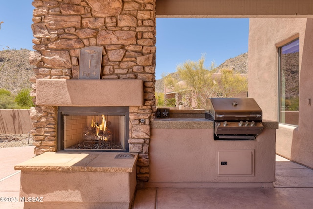 14198 N Gallery Pl, Marana, AZ 85658 - view of patio / terrace with an outdoor stone fireplace and a mountain view