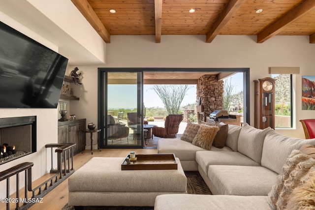 14198 N Gallery Pl, Marana, AZ 85658 - living room featuring a lit fireplace, recessed lighting, wood finished floors, wood ceiling with exposed beams, and plenty of natural light