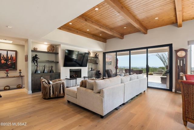 14198 N Gallery Pl, Marana, AZ 85658 - living room with wood ceiling with exposed beams, light wood-style flooring, a warm lit fireplace, and recessed lighting