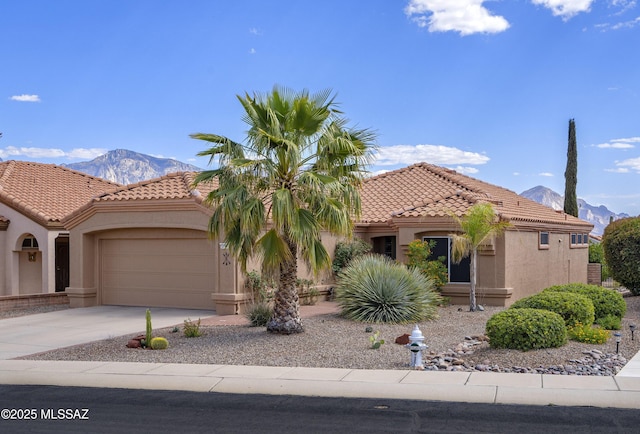 2246 E Amaranth St, Oro Valley, AZ 85755 - mediterranean / spanish house featuring a mountain view, stucco siding, a tiled roof, and a garage