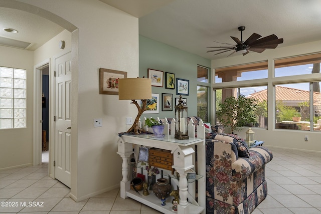 2246 E Amaranth St, Oro Valley, AZ 85755 - living room with arched walkways, ceiling fan, light tile patterned floors, and baseboards