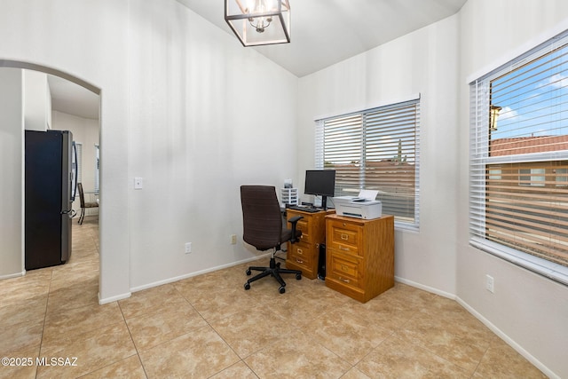 7746 S Trumpet Vine Ave, Tucson, AZ 85747 - office area with arched walkways, vaulted ceiling, baseboards, light tile patterned floors, and a chandelier